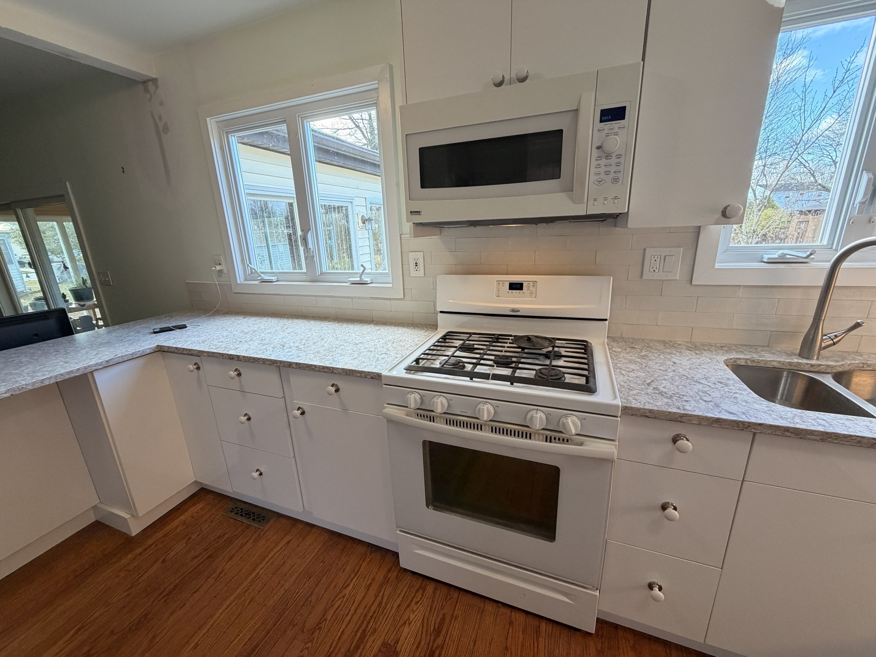 Completed white kitchen cabinetry and subway-tile backsplash in Evesham by Doug Does Anything